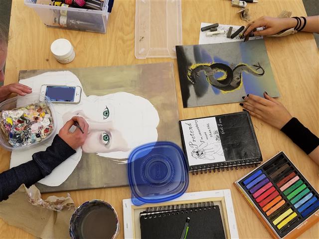 Students painting and drawing